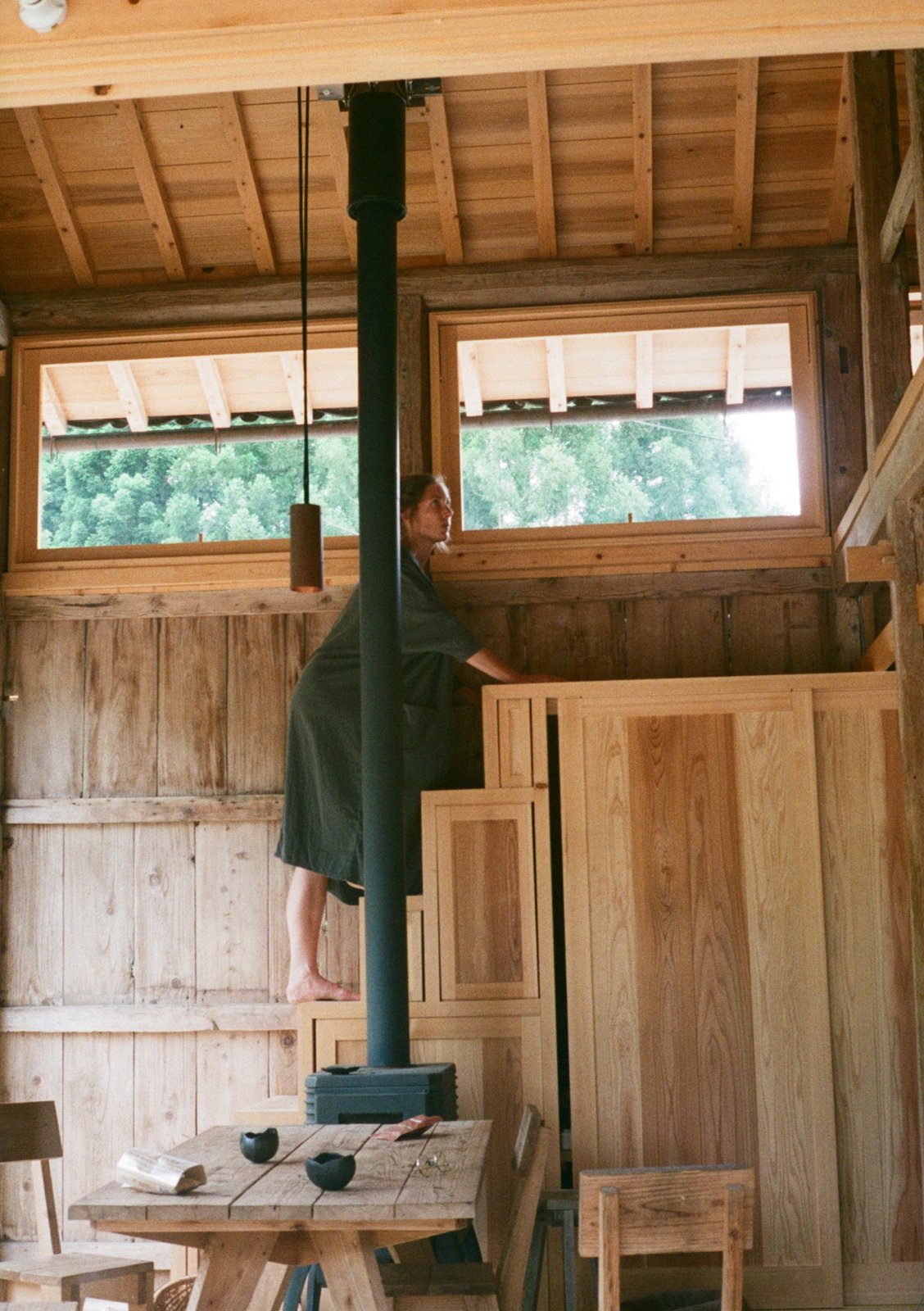 Mélanie climbs up the storage stairs in a large barn that has been converted into a dining room
